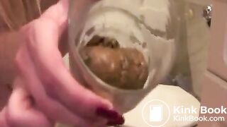 girl pooping into glass