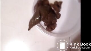 Cute Italian girl is pooping big hard logs in a white plate on the floor