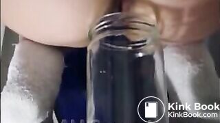 Woman pooping into jar.1