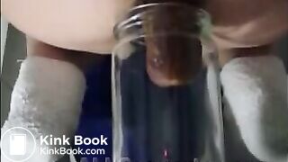 Woman pooping into jar.1