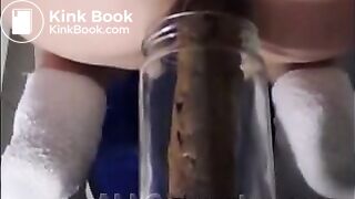 Woman pooping into jar.1