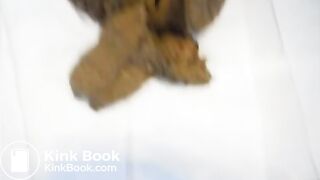 Brunette girl is pooping in the bathroom