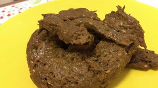 A blonde girl shit then scrutinized it.