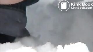 Woman pooping in the snow