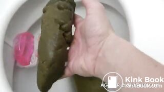 Dropping a big turd while fingering her cunt