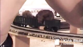 Girl shitting on a model train