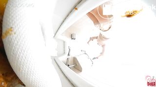 Japanese shitting on toilet.