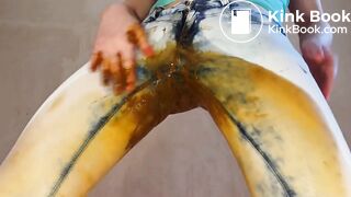 woman shits jeans and smears, puts on a show