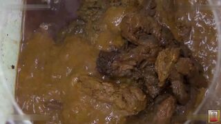 Women filling a glass box with shit