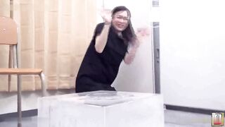 Women filling a glass box with shit