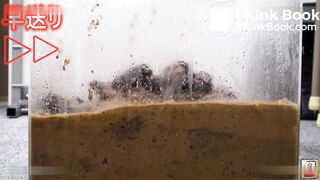 Women filling a glass box with shit
