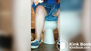 Woman shitting public toilet at restaurant.