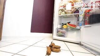 Woman pooping in ftont of the fridge