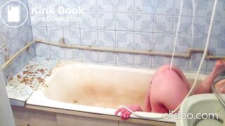 A beautiful girl in the bathroom gives herself an enema