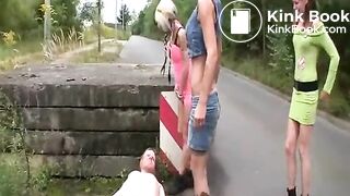 Three women pissing and shitting on a guy outdoors