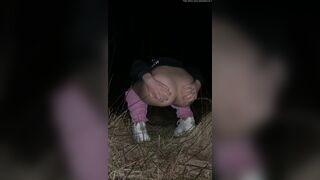 Girl pooping at night in the field