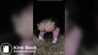 Girl pooping at night in the field