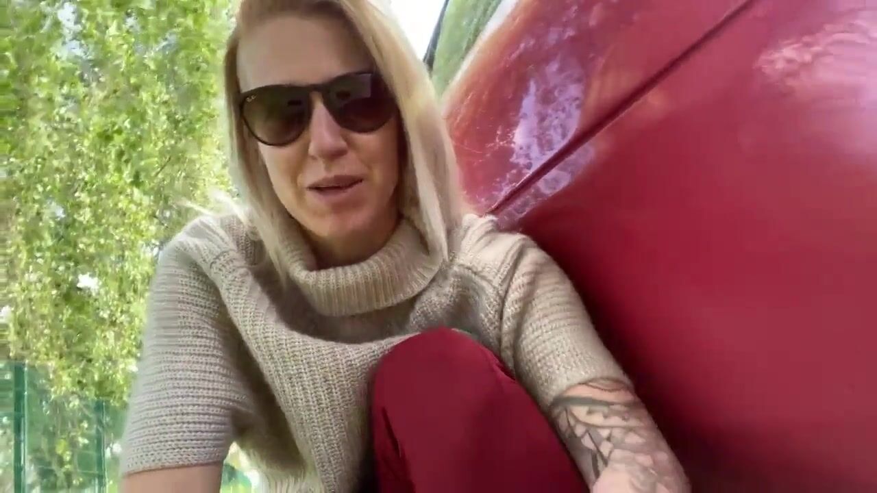 Woman pooping by the car
